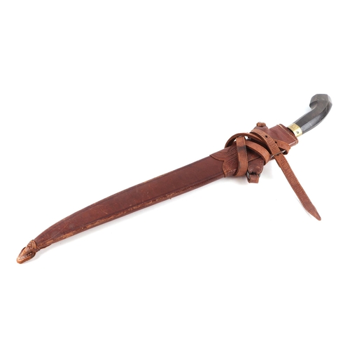 83 - A South American machete with hardwood handle and leather scabbard, 64cm long.