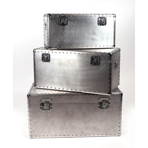 962 - A graduated set of three polished aluminium trunks. 80cm , 70cm & 60cm wide (3)