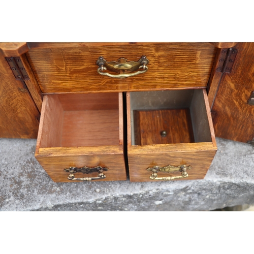 451 - A late Victorian / early Edwardian oak table to safe box, having twin doors opening to reveal three ... 