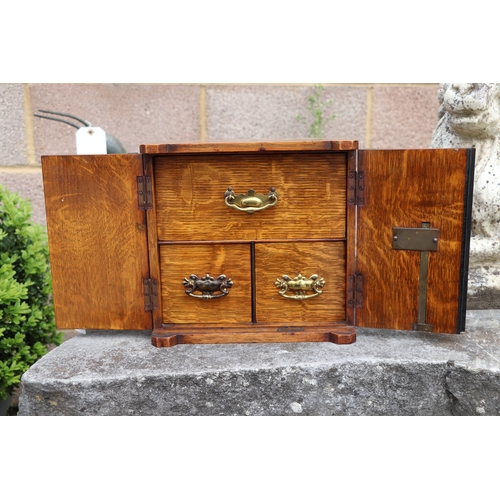 451 - A late Victorian / early Edwardian oak table to safe box, having twin doors opening to reveal three ... 