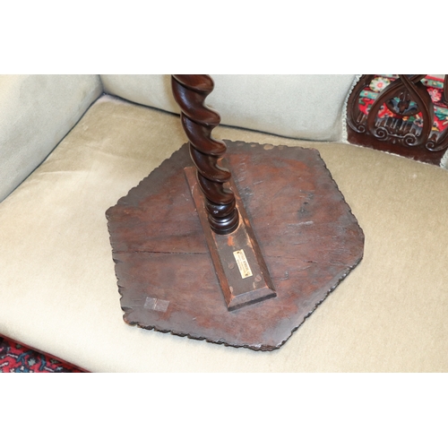 960 - A Victorian walnut occasional table, the carved hexagonal top on a barley twist column terminating o... 