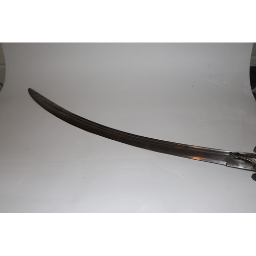 135 - An Indian Tulwar sword with white metal inlaid handle, 87cm long.