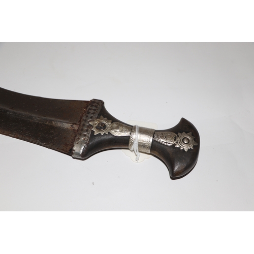 81 - A Middle Eastern Jambiya dagger with leather scabbard, 34cm long.