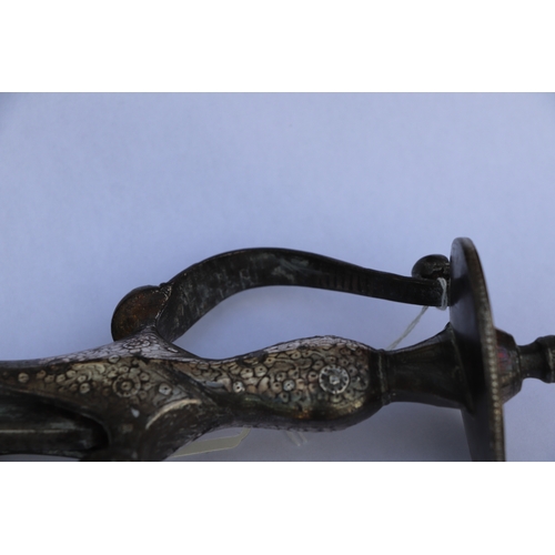 136 - An Indian Tulwar sword and leather scabbard, with white metal inlaid handle, 90cm long.