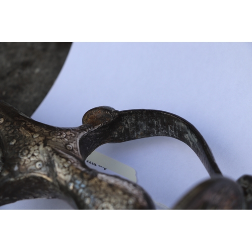 136 - An Indian Tulwar sword and leather scabbard, with white metal inlaid handle, 90cm long.