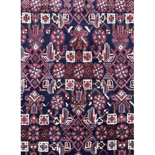 121 - A fine quality Persian Hamadan woollen hand knotted runner with repeating stylised floral design wit... 