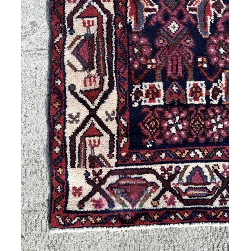 121 - A fine quality Persian Hamadan woollen hand knotted runner with repeating stylised floral design wit... 