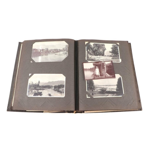 20 - An early 20th century photo album containing World Tour and Military photos; together with a postcar... 