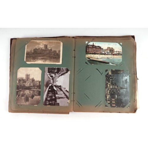 21 - An early 20th century postcard album; together with a quantity of photographs and ephemera.