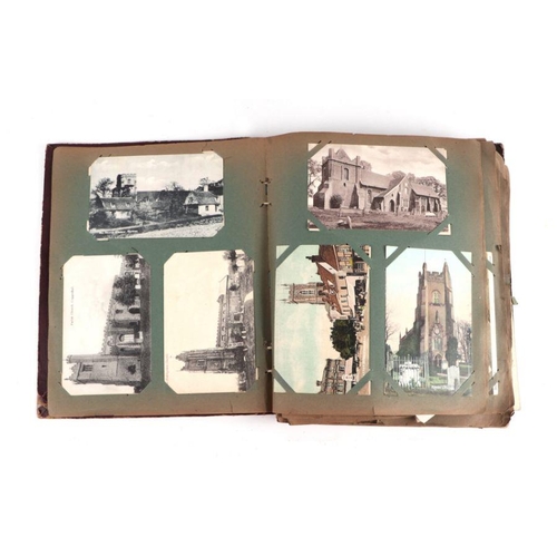 21 - An early 20th century postcard album; together with a quantity of photographs and ephemera.