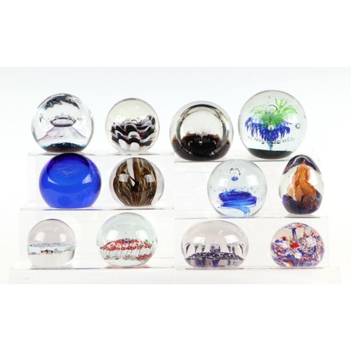 252 - A collection of glass paperweights to include Selkirk and Caithness.