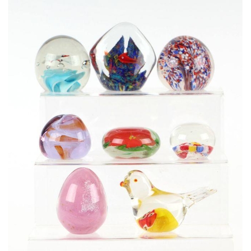 253 - A collection of glass paperweights to include Caithness, Murano and Selkirk.