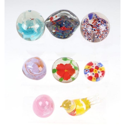 253 - A collection of glass paperweights to include Caithness, Murano and Selkirk.