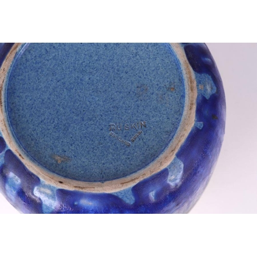 318 - A Ruskin Pottery pot with drip glaze decoration, impressed mark to base, 22cms high.