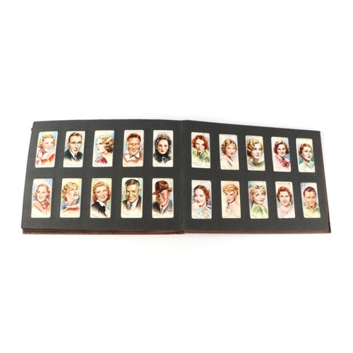 33 - An album of cigarette cards including John Player & Sons Cricketers 1934, Football, Rugby, Actors an... 