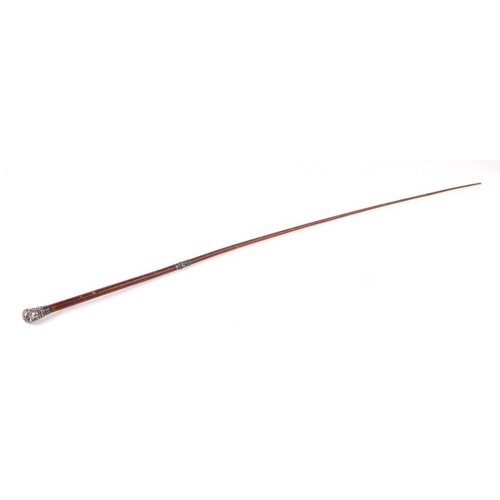 333 - A Victorian ladies leather riding crop / whip with white metal collar and terminal. 72cm long