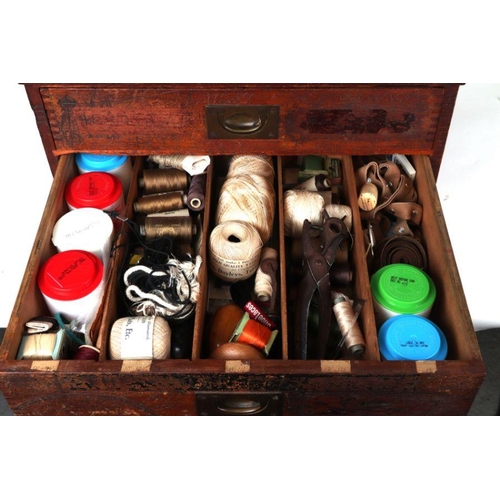 360 - A haberdasher's stained wooden two-drawer chest  containing a large amount of sewing related items, ... 