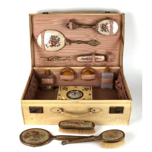 362 - A pigskin suitcase with fitted interior containing a petit point dressing table set.