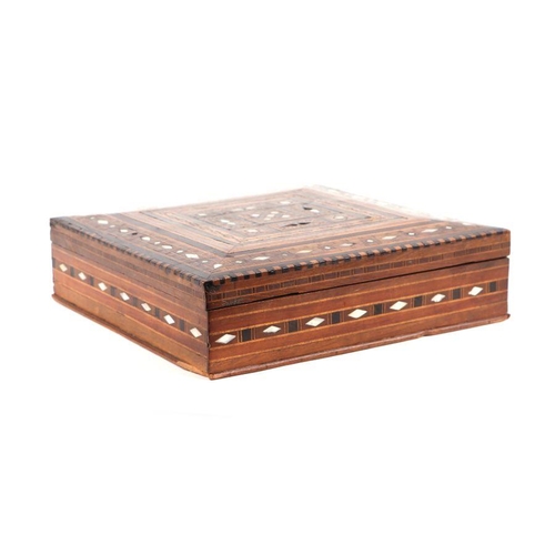 371 - A Cairo ware wooden box with inlaid mother of pearl and geometric wooden inlay, 26cms wide.