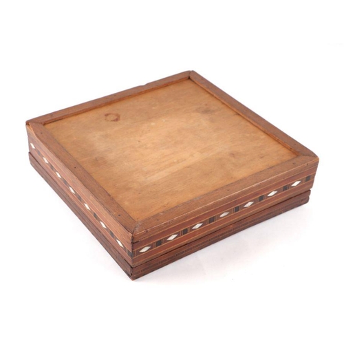 371 - A Cairo ware wooden box with inlaid mother of pearl and geometric wooden inlay, 26cms wide.