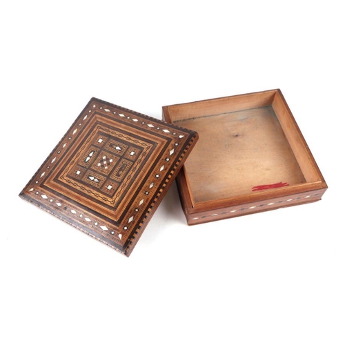 371 - A Cairo ware wooden box with inlaid mother of pearl and geometric wooden inlay, 26cms wide.