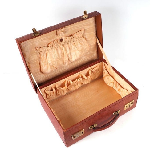 373 - A vintage red leather suitcase, 45cms wide.