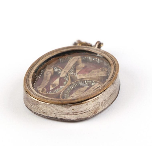 377 - An 18th century religious reliquary locket dedicated to four different saints, mounted on an ecclesi... 