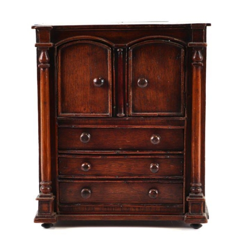 422 - A 19th century apprentice piece, a miniature cabinet, the pair of cupboard doors above three long dr... 