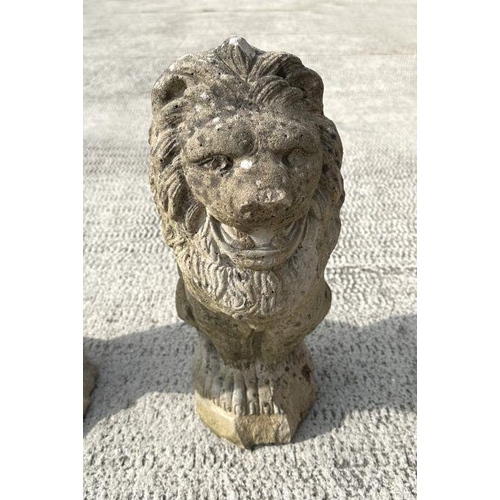 6 - A group of three well weathered stone figures of seated lions, each 44cms high (3).