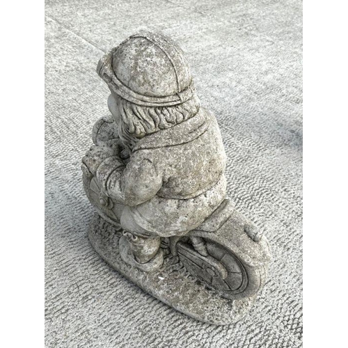 7 - A weathered concrete figure of a gnome riding a motorcycle,58cms high; together with a similar figur... 