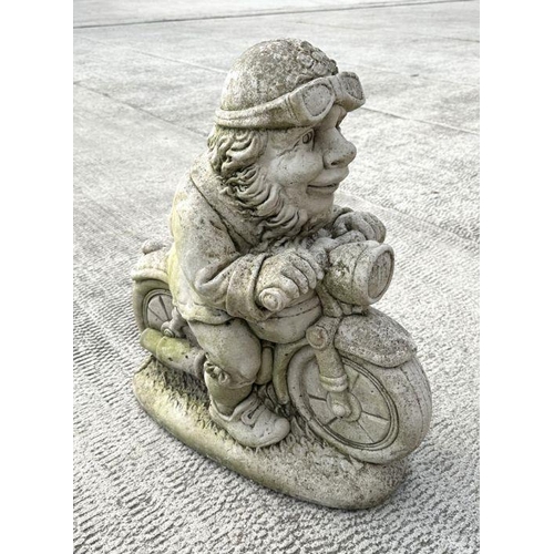 7 - A weathered concrete figure of a gnome riding a motorcycle,58cms high; together with a similar figur... 