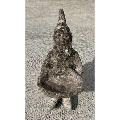 7 - A weathered concrete figure of a gnome riding a motorcycle,58cms high; together with a similar figur... 