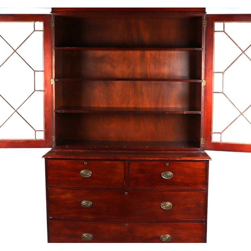 864 - A 19th century mahogany bookcase on chest, the pair of astragal glazed doors enclosing a shelved int... 