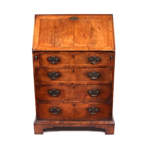 866 - A George II style walnut bureau, the fall-front revealing a fitted interior above three long drawers... 
