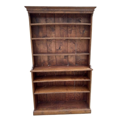 895 - A modern oak open bookcase with adjustable shelves, 122cms wide.