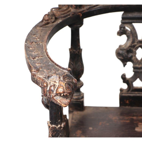 899 - An early 19th century continental oak window seat with cherub head and griffin carvings and dragon h... 