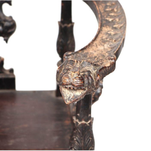 899 - An early 19th century continental oak window seat with cherub head and griffin carvings and dragon h... 