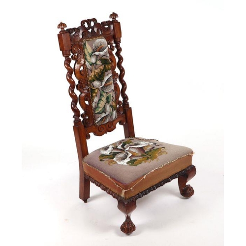 900 - A Victorian rosewood nursing chair with beadwork upholstered seat and back.