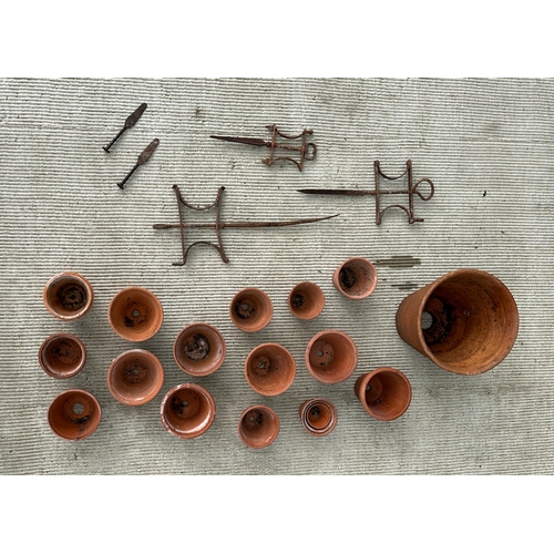 9 - A quantity of terracotta flower pots and line markers.