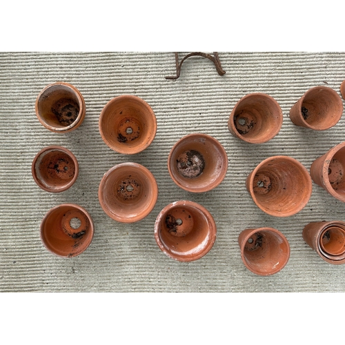 9 - A quantity of terracotta flower pots and line markers.