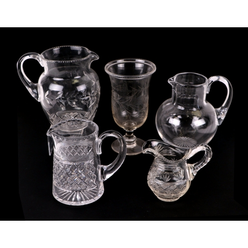 260 - A quantity of glassware to include 19th century cut glass milk jugs, other jugs and bowls, cut glass... 