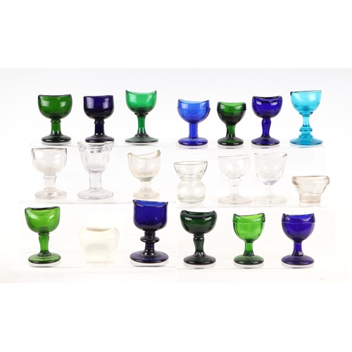 261 - A large collection of eye baths to include, blue, green and clear glass examples.