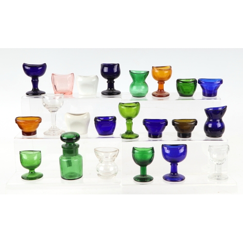 261 - A large collection of eye baths to include, blue, green and clear glass examples.