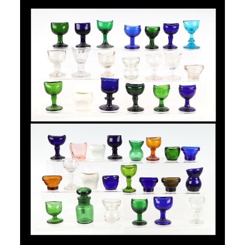 261 - A large collection of eye baths to include, blue, green and clear glass examples.