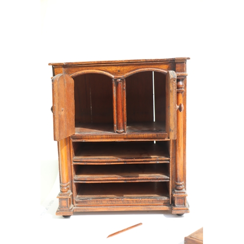 422 - A 19th century apprentice piece, a miniature cabinet, the pair of cupboard doors above three long dr... 