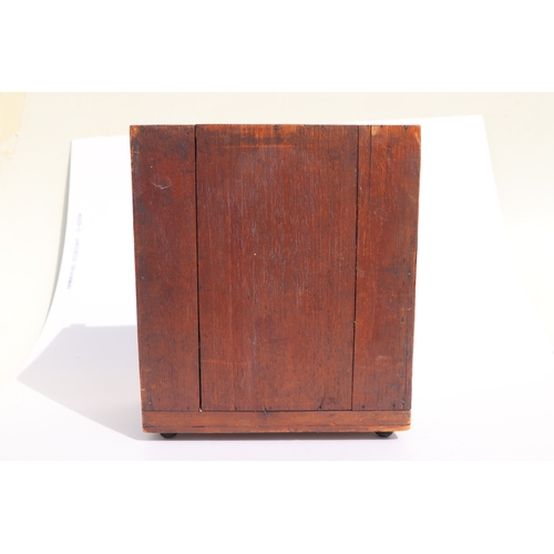 422 - A 19th century apprentice piece, a miniature cabinet, the pair of cupboard doors above three long dr... 