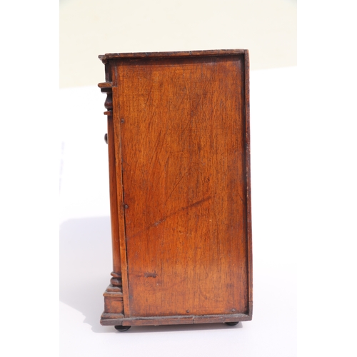 422 - A 19th century apprentice piece, a miniature cabinet, the pair of cupboard doors above three long dr... 