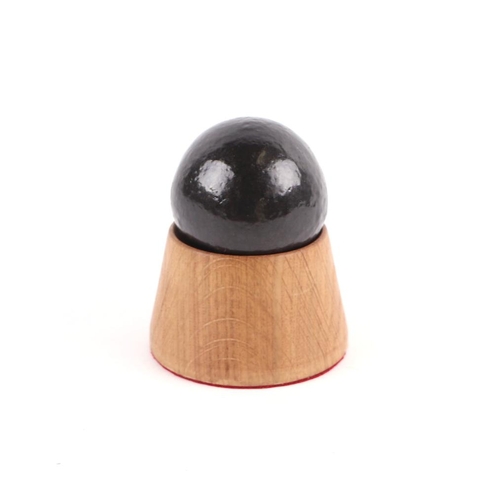 115 - A roundshot cannon ball. Approximate diameter of 6.5cms (2.5ins) mounted on a turned oak mount