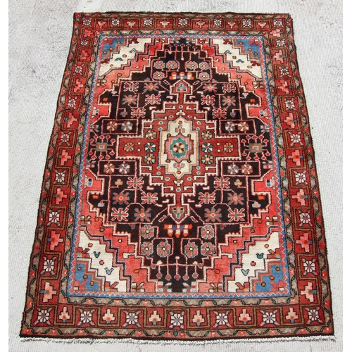 181 - A Persian Hamadan rug with geometric design, on a beige ground, 210 by 140cms.