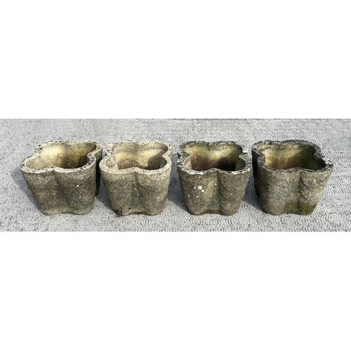62 - A set of four well weathered reconstituted stone lobed form planters, 32cms wide; together with a te... 